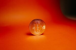 a gold coin on a red surface